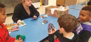 Hailey teaching Uno with the boys